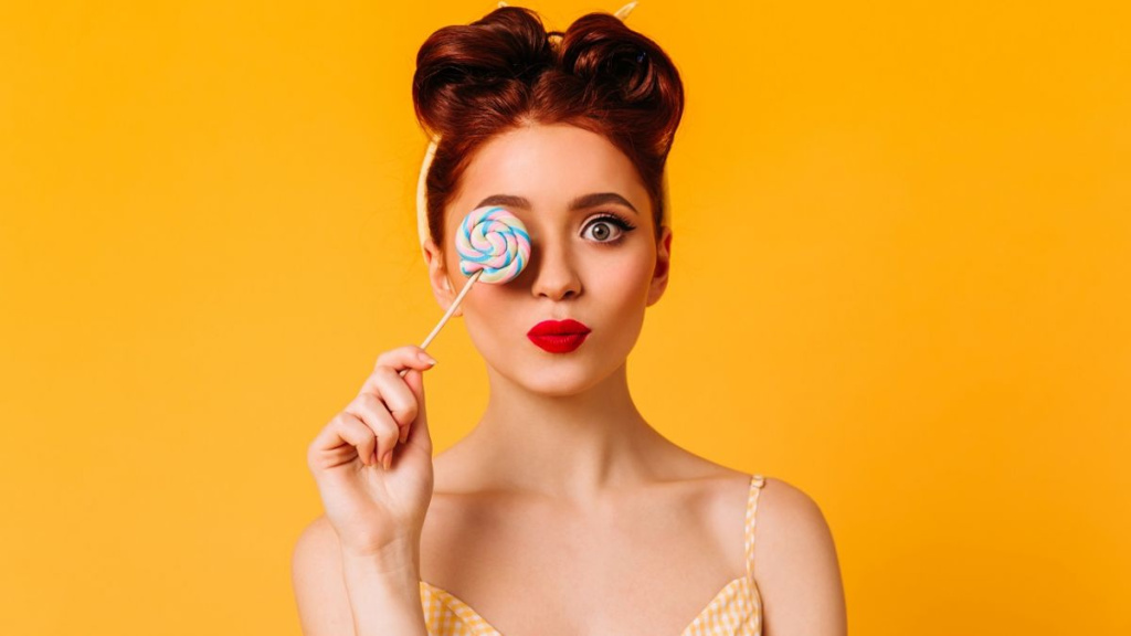lovable_female_model_holding_hard_candy_studio_shot_inspired_ginger_girl_with_lollipop_isolated_yellow_space_1200x675 (1).jpg как снизить аппетит и тягу к сладкому